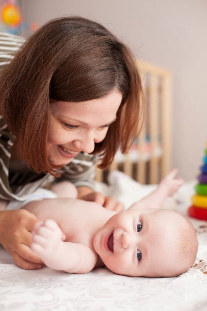 pexels-photo-11769506 A mother lovingly plays with her laughing baby, capturing a tender and joyful moment.