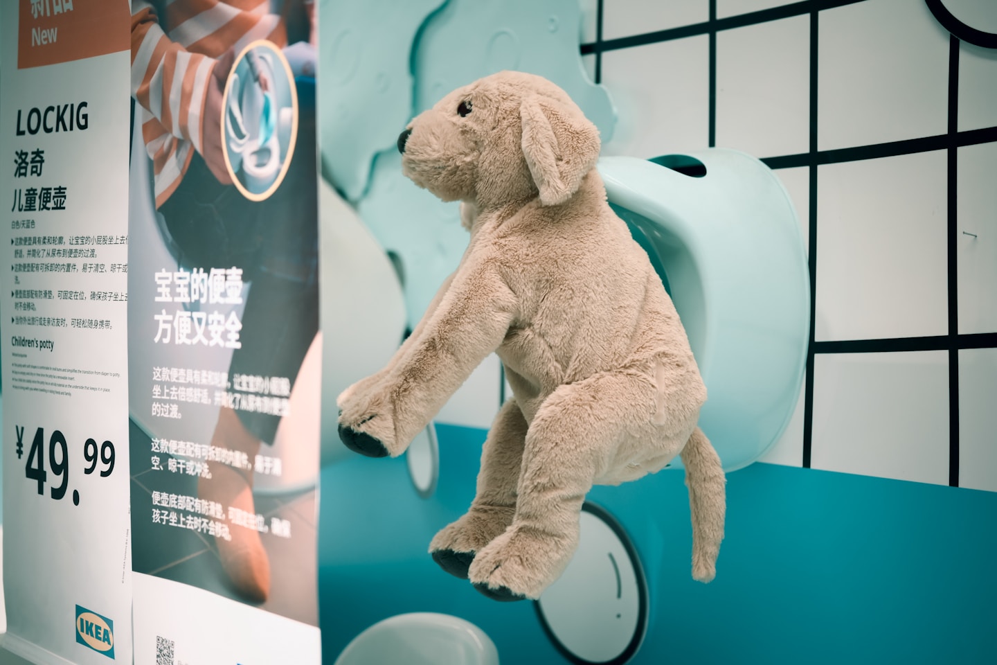 Plush dog toy climbing on a display