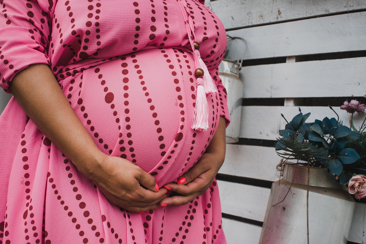 women's pink and red long-sleeved maternity dress